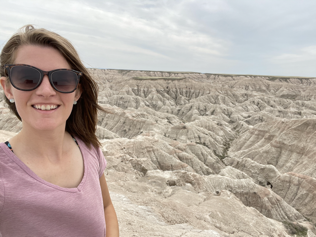 Ashley overlooking geological formations at Badlands National Park